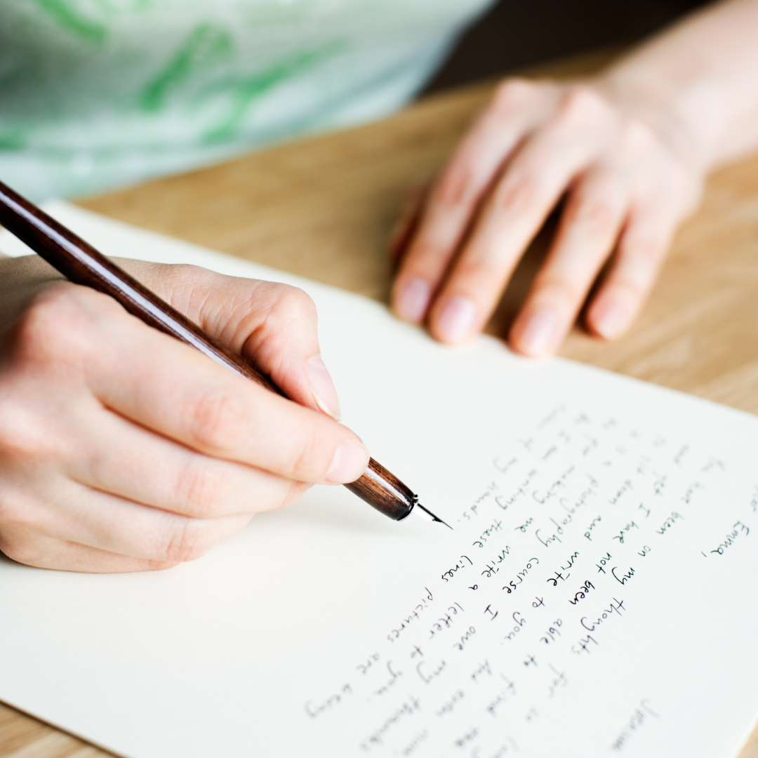 person writing a letter